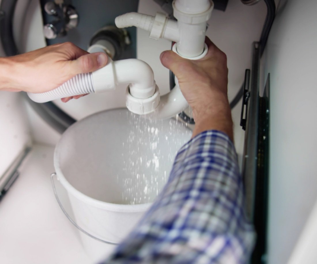 Dégorgement d'un siphon d'évier dans un seau
